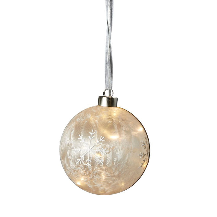 Glaskula med LED och snöflingor